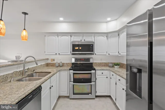 a kitchen with a sink stove and refrigerator