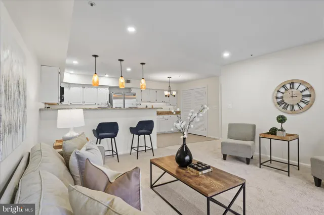 a kitchen with a dining table chairs and white cabinets