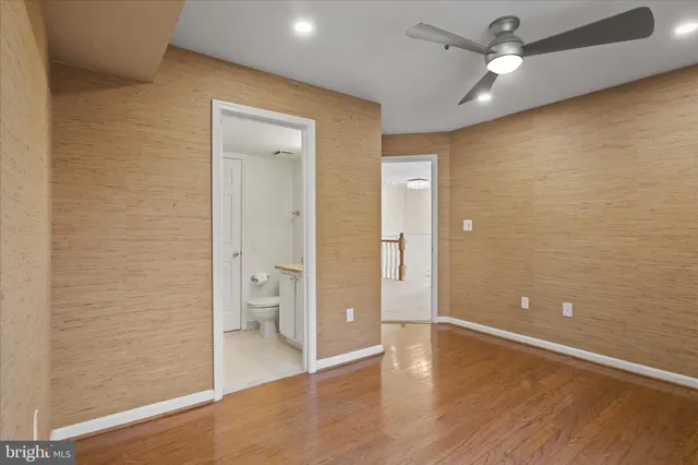 wooden floor in an empty room and a bathroom