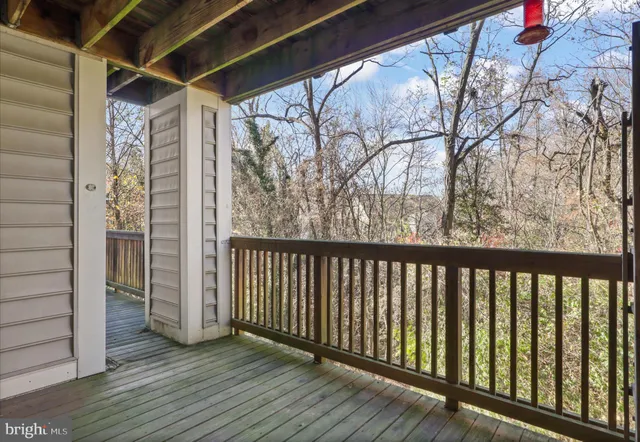 a view of a balcony with wooden floor