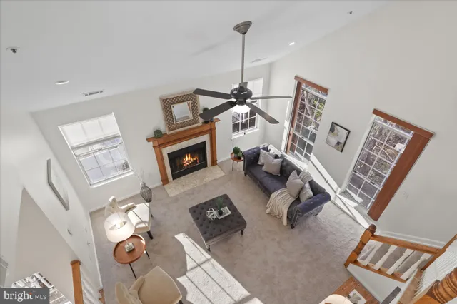 a living room with furniture a rug and white walls