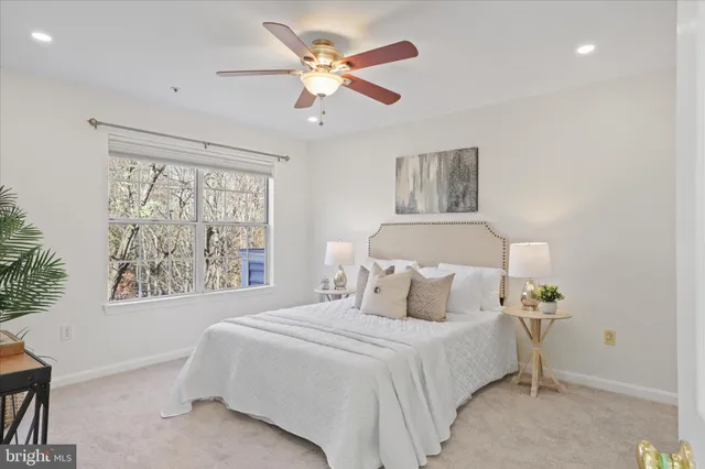 a bedroom with a large bed and a window