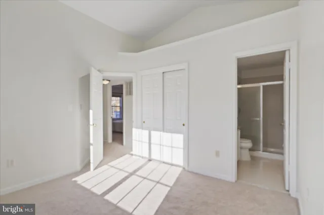 a view of an empty room and closet area