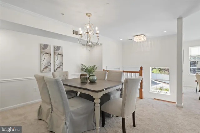 a view of a dining room with furniture and chandelier