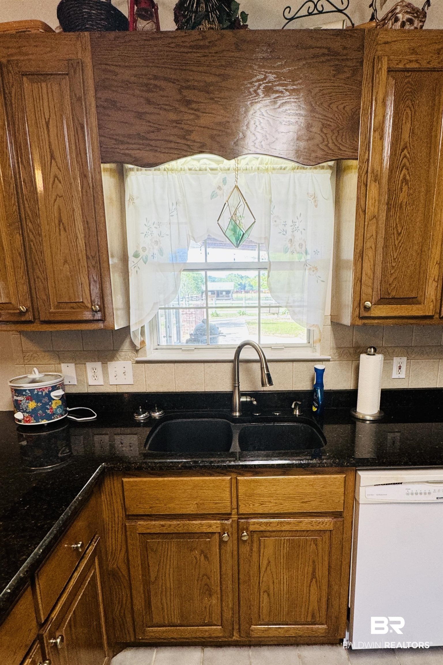 13795 White Road Silverhill, AL 36576 - Photo 33 of 99 Kitchen with wood finish cabinetry, dark stone counters, white dishwasher, and tasteful backsplash