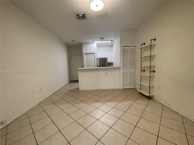 a view of a kitchen space with the cabinets