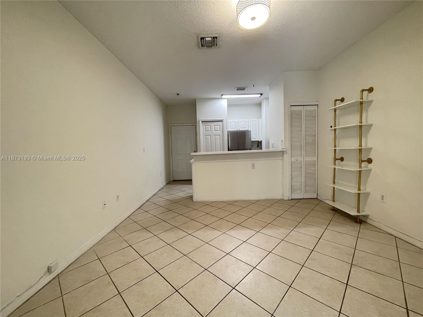 2734 Bird Avenue, Unit 205 Miami, FL 33133 - Photo 6 of 20 a view of a refrigerator and window in a room