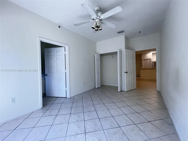 an empty room & a ceiling fan in a room