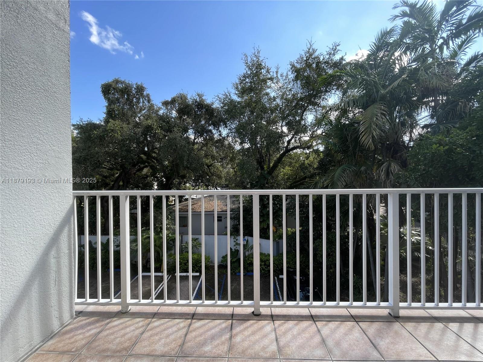 2734 Bird Avenue, Unit 205 Miami, FL 33133 - Photo 10 of 20 a balcony with wooden fence