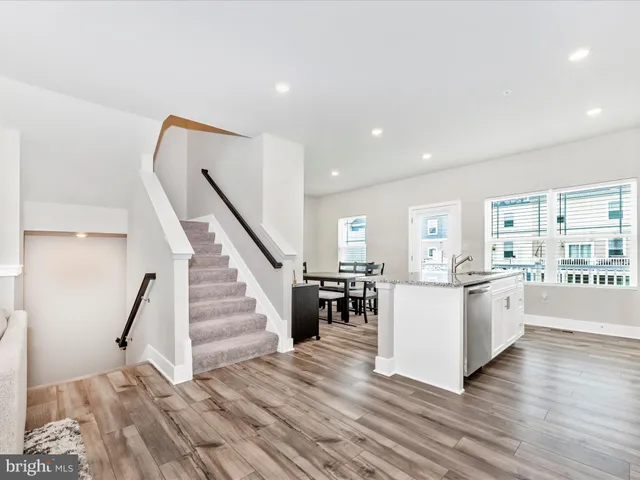 a view of a kitchen with furniture and wooden floor