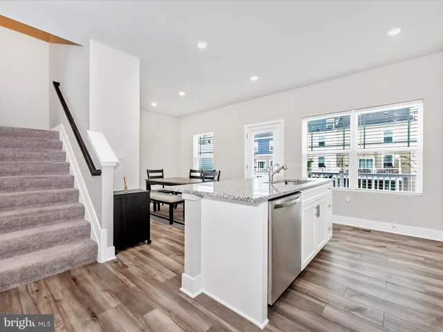 a kitchen with sink and wooden floor