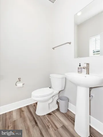 a bed sitting in a spacious bedroom next to a window