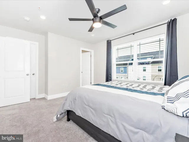 a bedroom with a bed and a ceiling fan