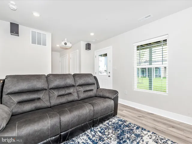 a large building with a garden and pathway