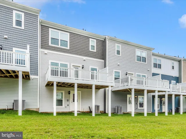 a front view of a building with a garden