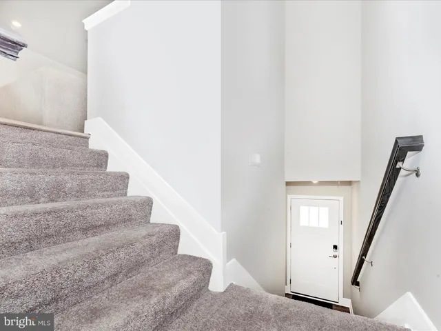a view of staircase with white walls