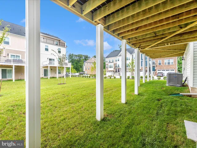 a front view of a residential apartment building with a yard