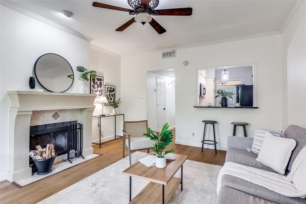 8555 Fair Oaks Crossing, Unit 702 Dallas, TX 75243 - Photo 16 of 26 a living room with furniture and a fireplace