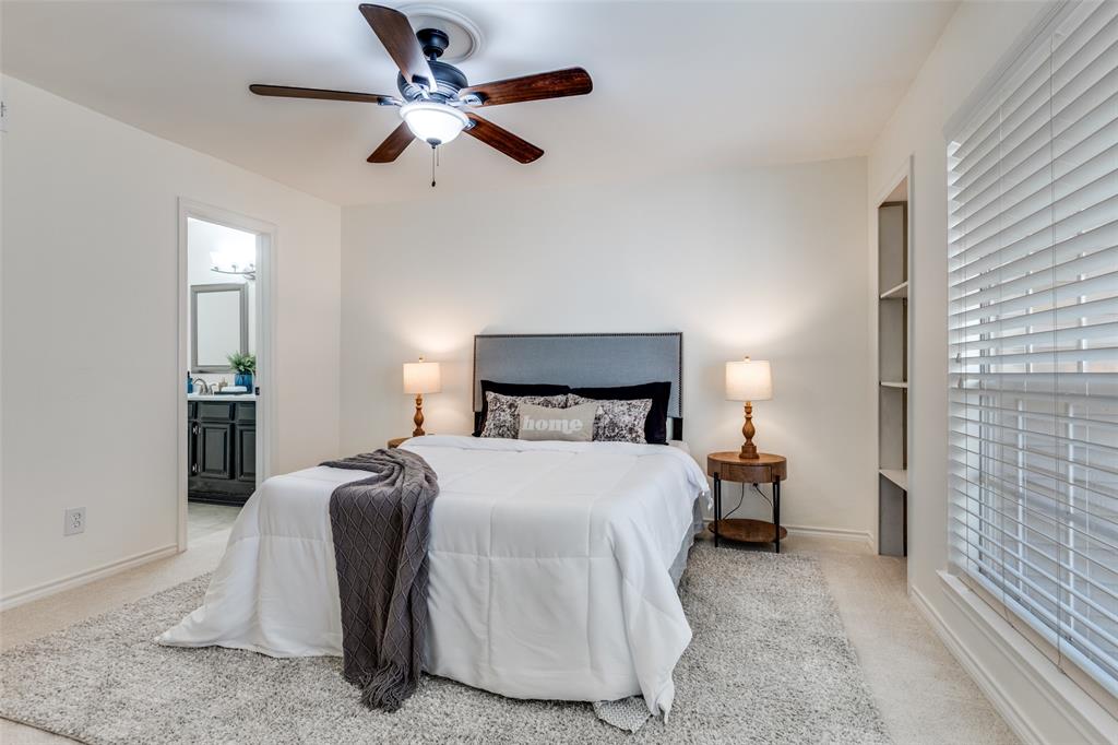 8555 Fair Oaks Crossing, Unit 702 Dallas, TX 75243 - Photo 19 of 26 a bedroom with a bed and a chandelier