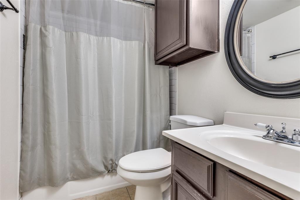 8555 Fair Oaks Crossing, Unit 702 Dallas, TX 75243 - Photo 22 of 26 a bathroom with a sink a toilet and a mirror