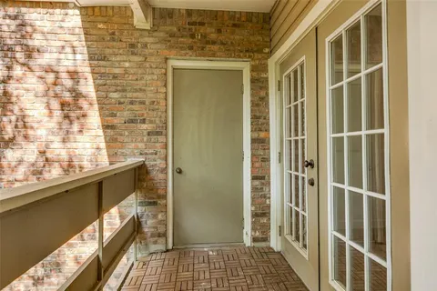 a view of a wooden bench in a balcony