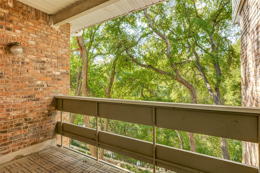 8555 Fair Oaks Crossing, Unit 702 Dallas, TX 75243 - Photo 24 of 26 a view of a wooden bench in a balcony