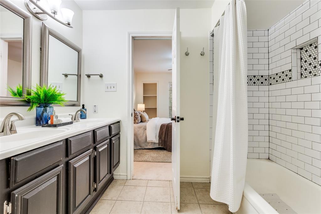 8555 Fair Oaks Crossing, Unit 702 Dallas, TX 75243 - Photo 4 of 26 a bathroom with a double vanity sink a mirror a bathtub and shower