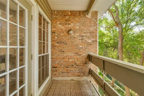 a view of a balcony with wooden floor and door