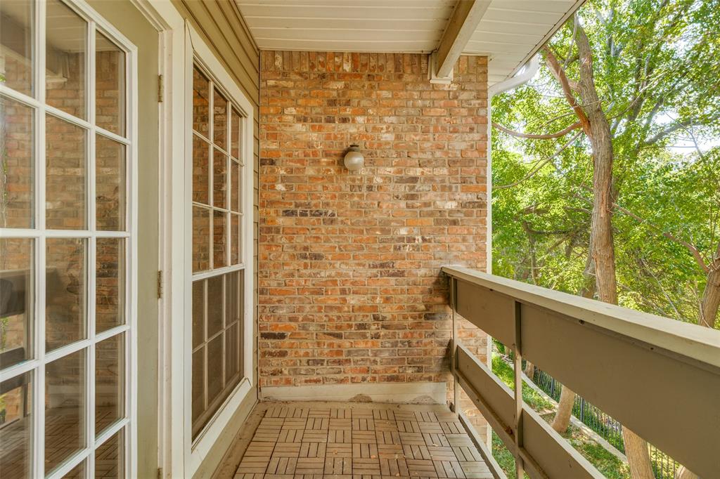 8555 Fair Oaks Crossing, Unit 702 Dallas, TX 75243 - Photo 6 of 26 a view of a balcony with wooden floor and door