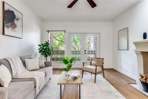 a living room with furniture and a potted plant