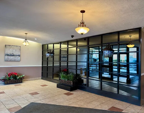 a bathroom with a glass door shower and a sink