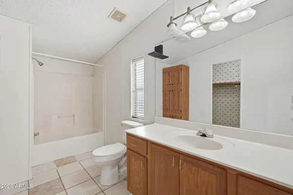 a bathroom with a double vanity sink mirror and toilet
