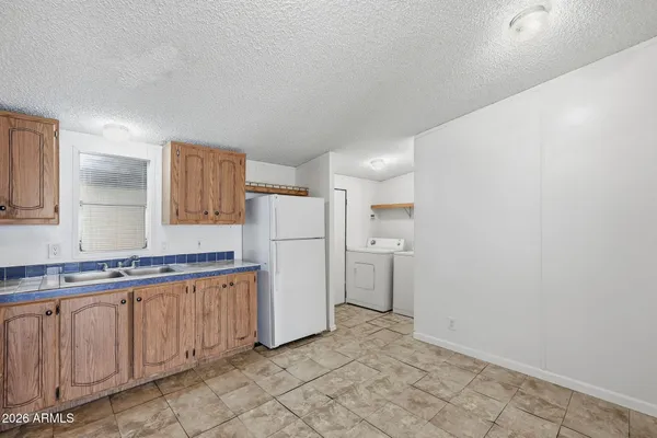 a view of a kitchen with refrigerator and microwave