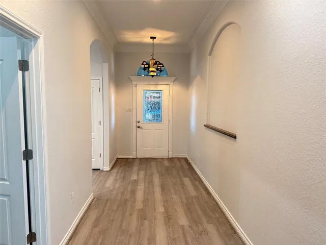 a view of hallway with wooden floor