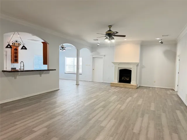 wooden floor fireplace and windows in an empty room