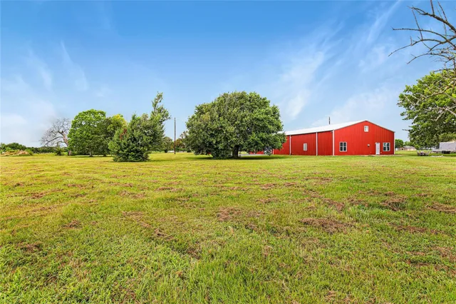 a view of yard with swimming pool and green space