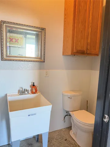a bathroom with a toilet a sink and a mirror