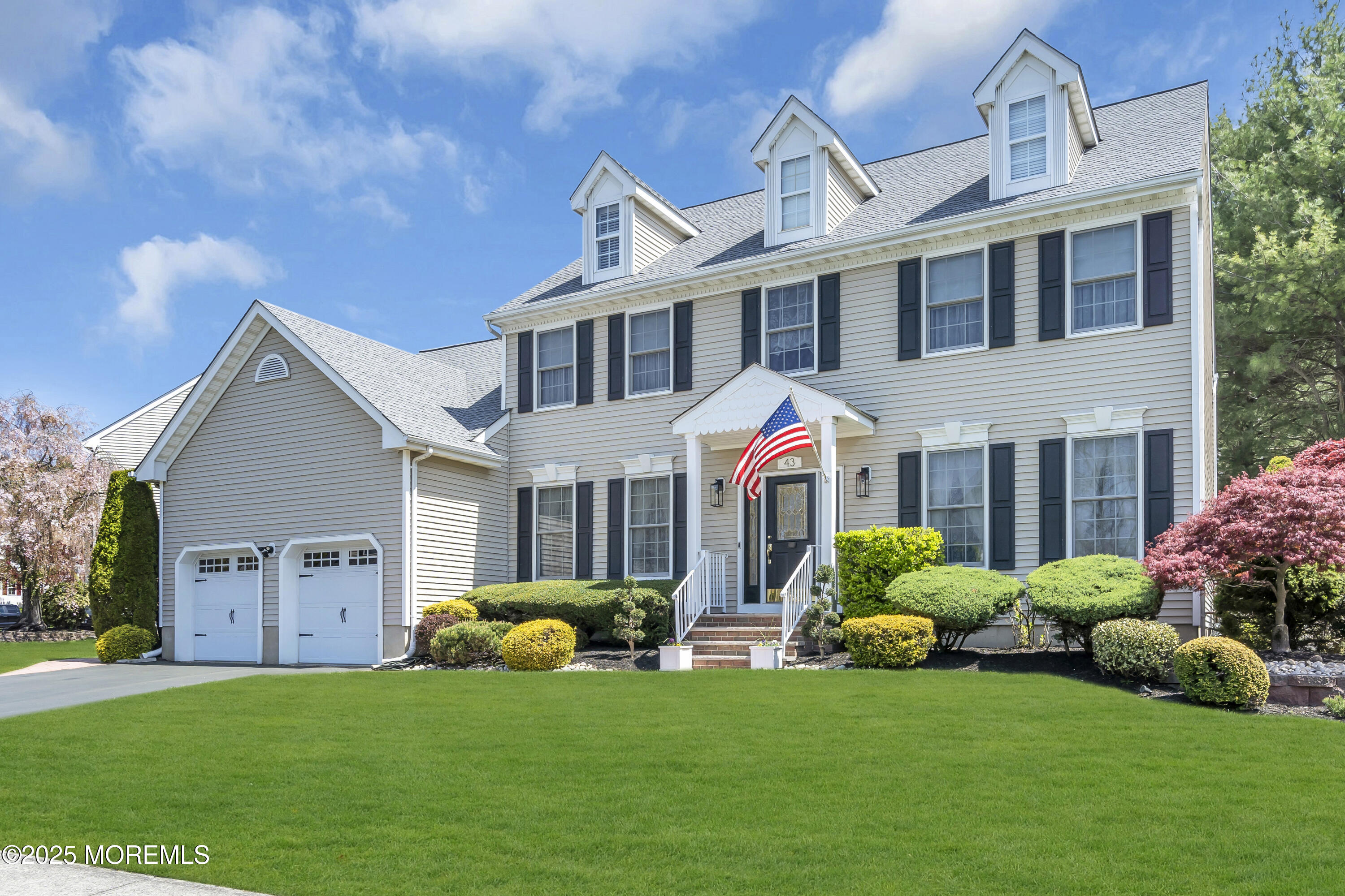 a front view of house with yard and green space
