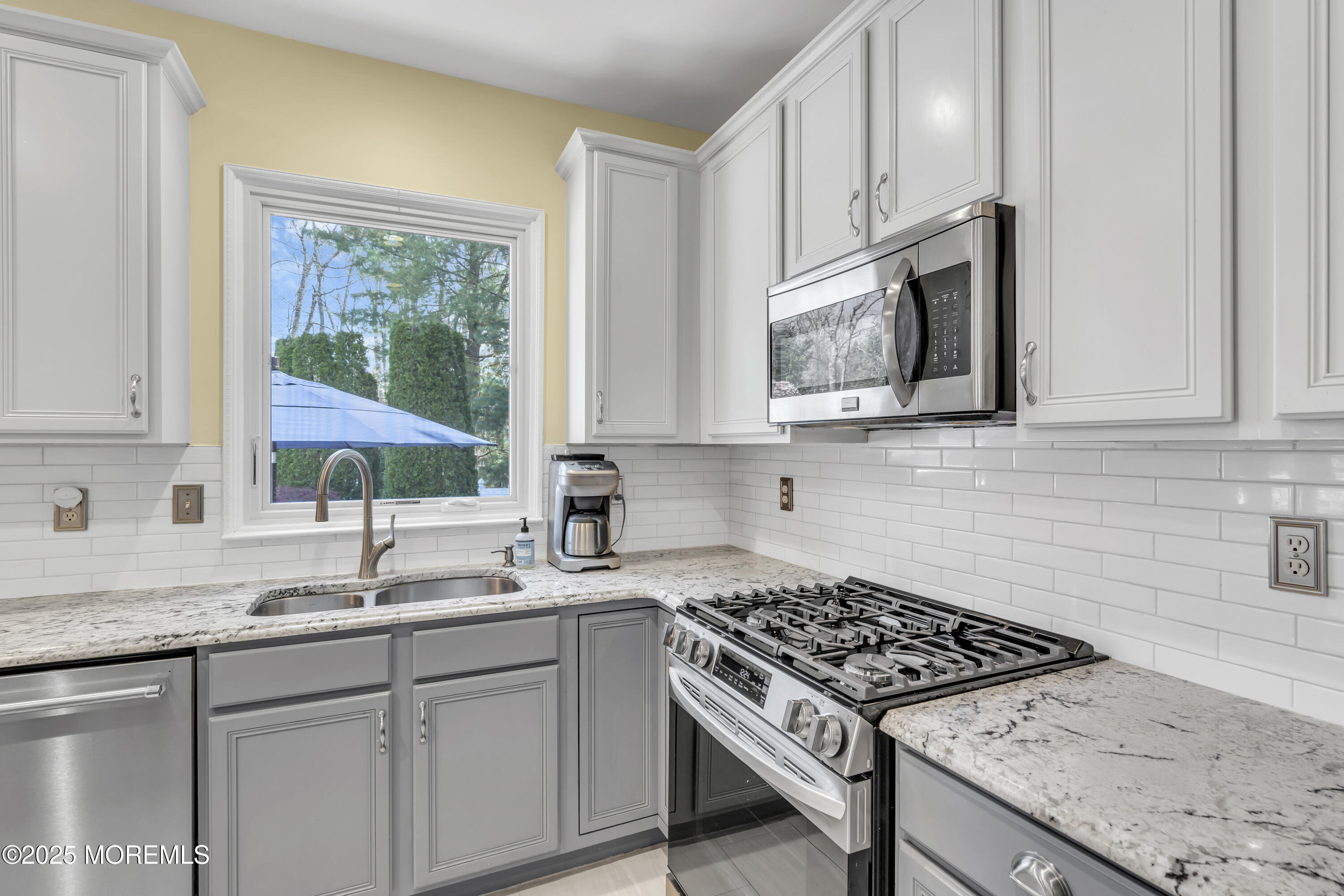 43 Periwinkle Circle Tinton Falls, NJ 07712 - Photo 19 of 60 a kitchen with stainless steel appliances granite countertop white cabinets and window