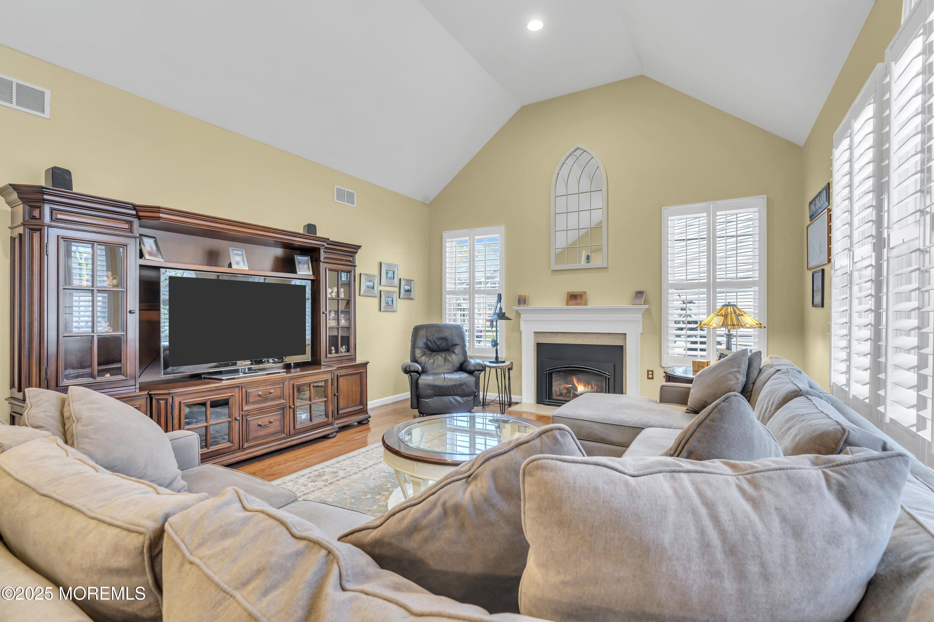 43 Periwinkle Circle Tinton Falls, NJ 07712 - Photo 28 of 60 a living room with furniture a fireplace and a flat screen tv