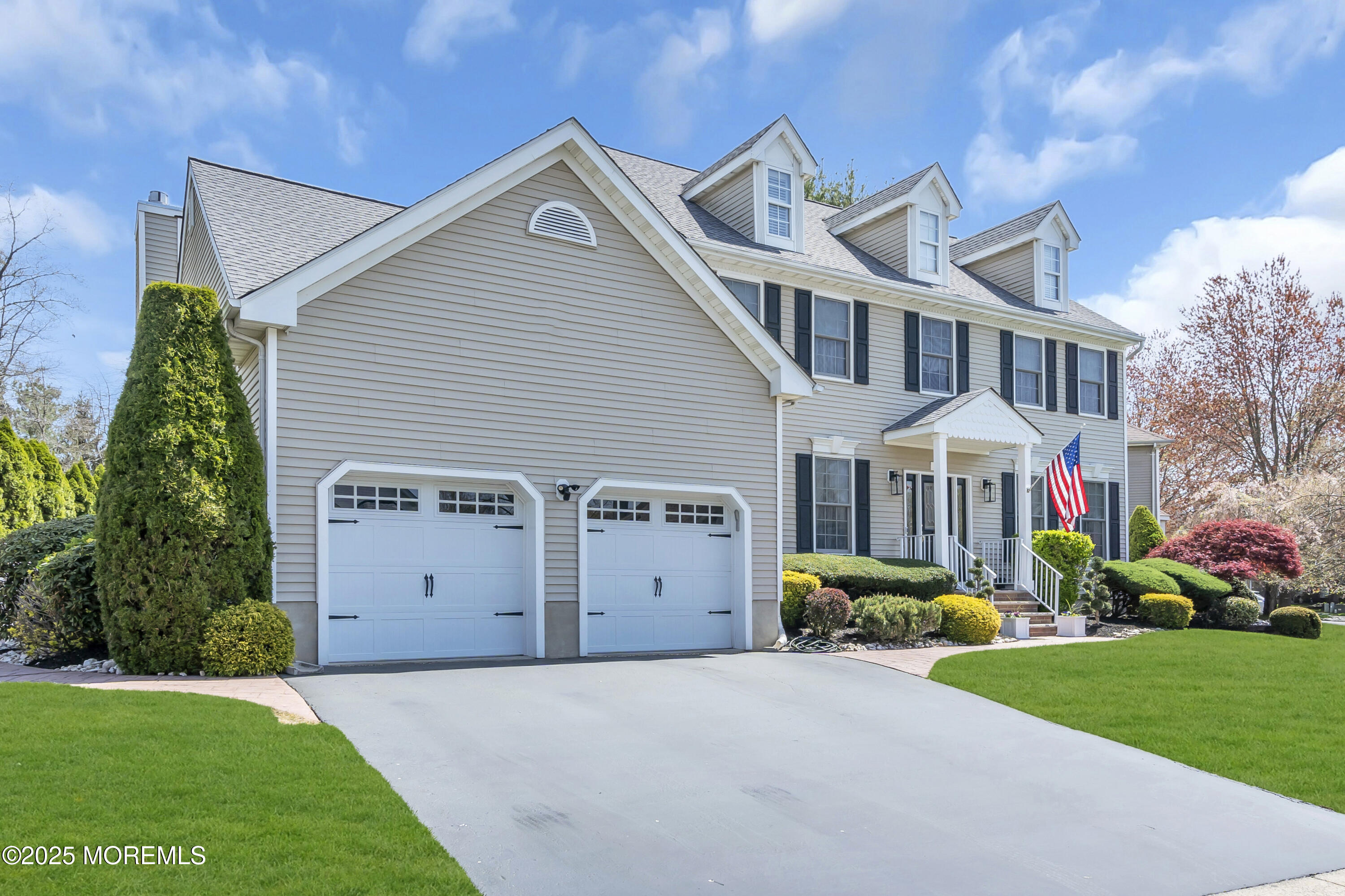 43 Periwinkle Circle Tinton Falls, NJ 07712 - Photo 3 of 60 a front view of a house with a garden and plants