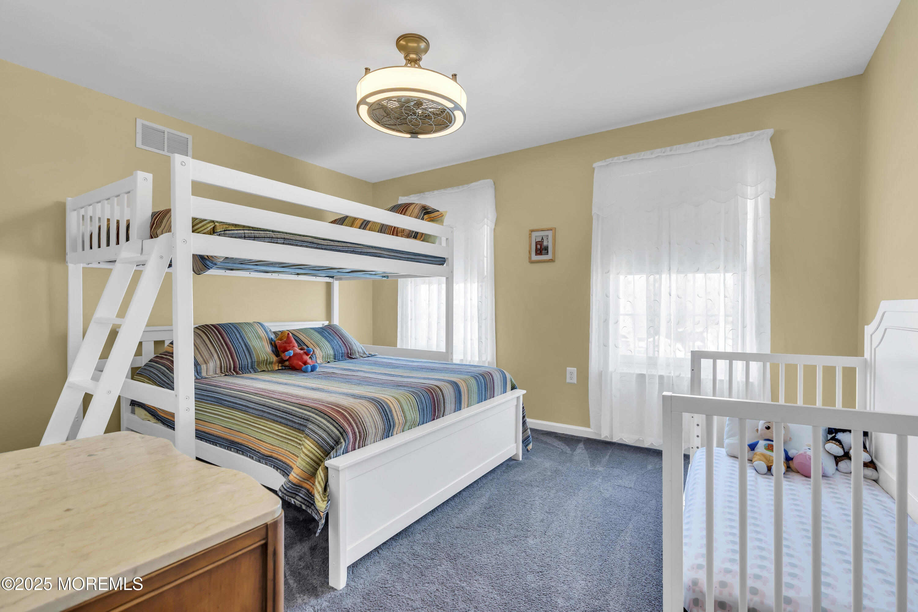 43 Periwinkle Circle Tinton Falls, NJ 07712 - Photo 38 of 60 a living room with a couch and a chandelier