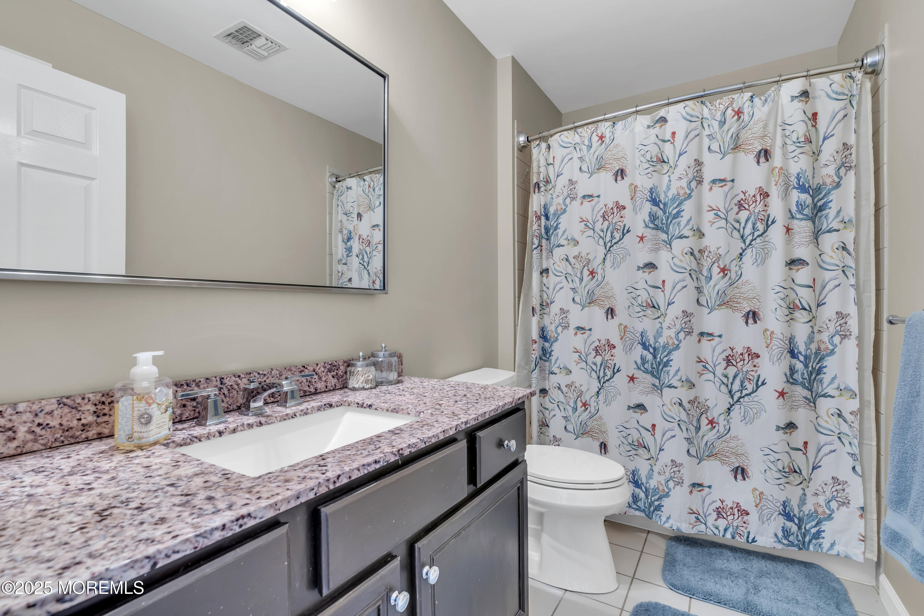 43 Periwinkle Circle Tinton Falls, NJ 07712 - Photo 40 of 60 a bathroom with a granite countertop sink a toilet and a mirror