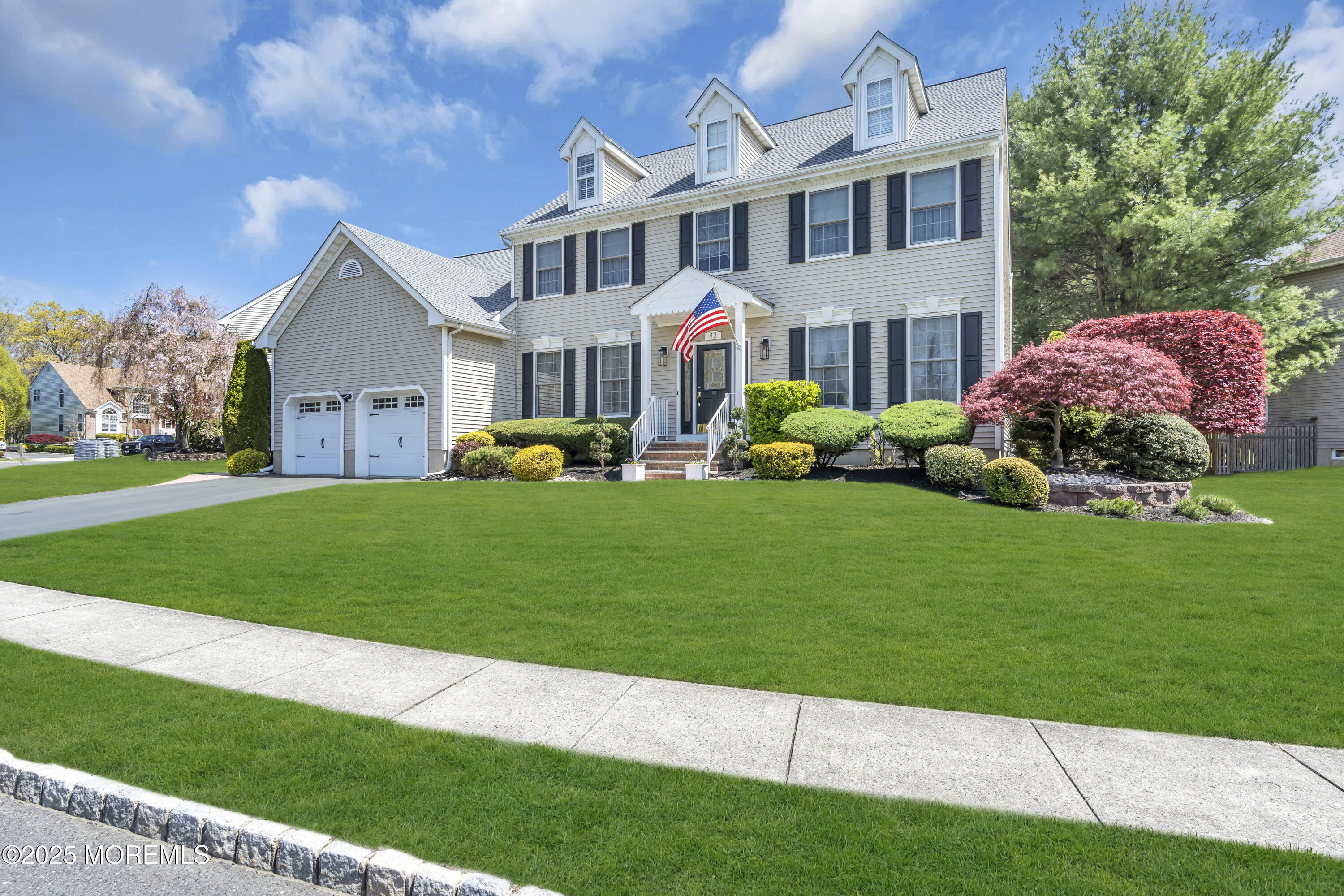 43 Periwinkle Circle Tinton Falls, NJ 07712 - Photo 5 of 60 a front view of a house with a garden and plants