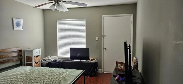 a bedroom with a bed and a television