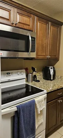 a stove top oven sitting inside of a kitchen