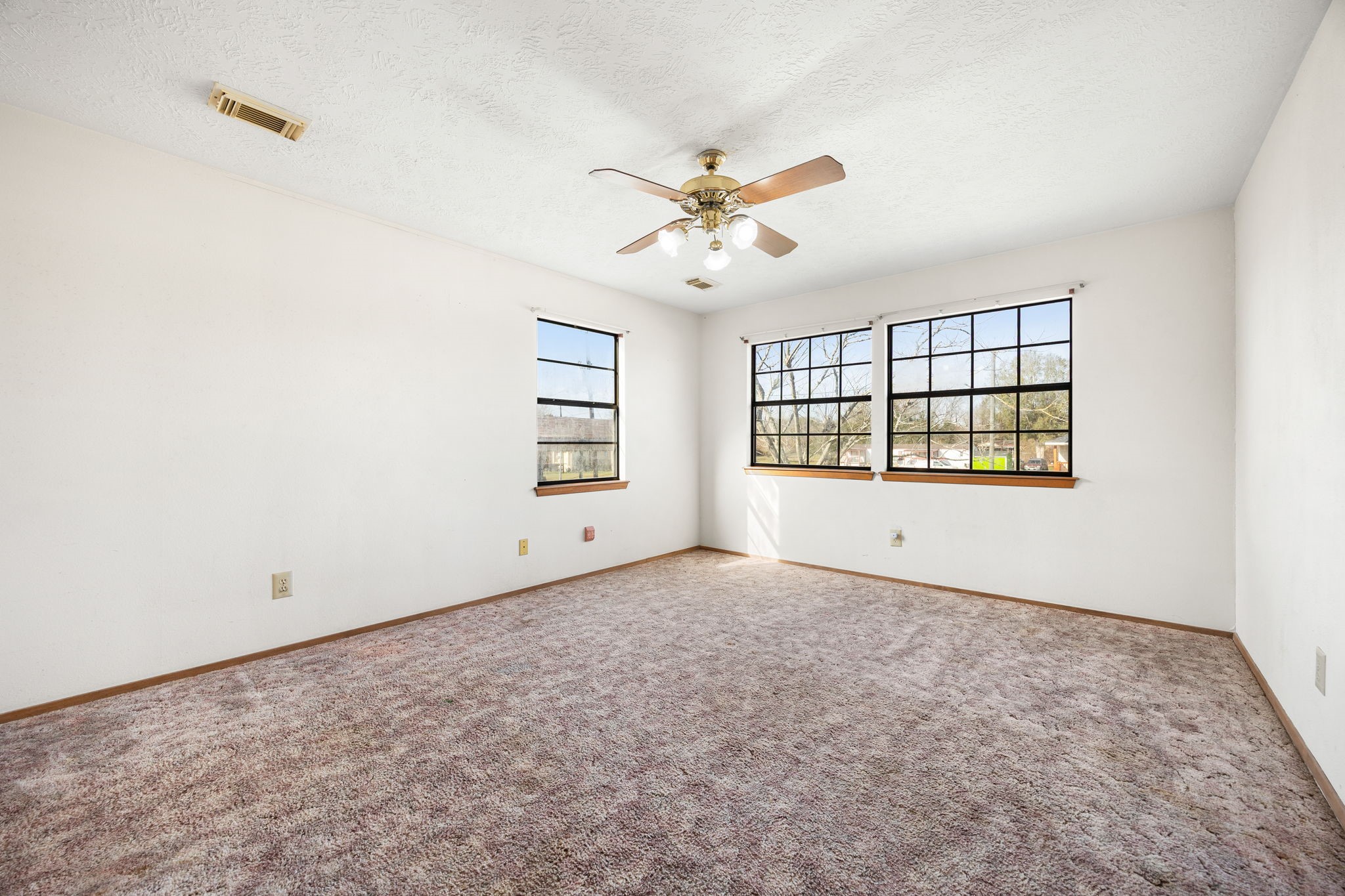 236 Pine Ridge Drive Cleveland, TX 77327 - Photo 17 of 30 an empty room with windows and ceiling fan
