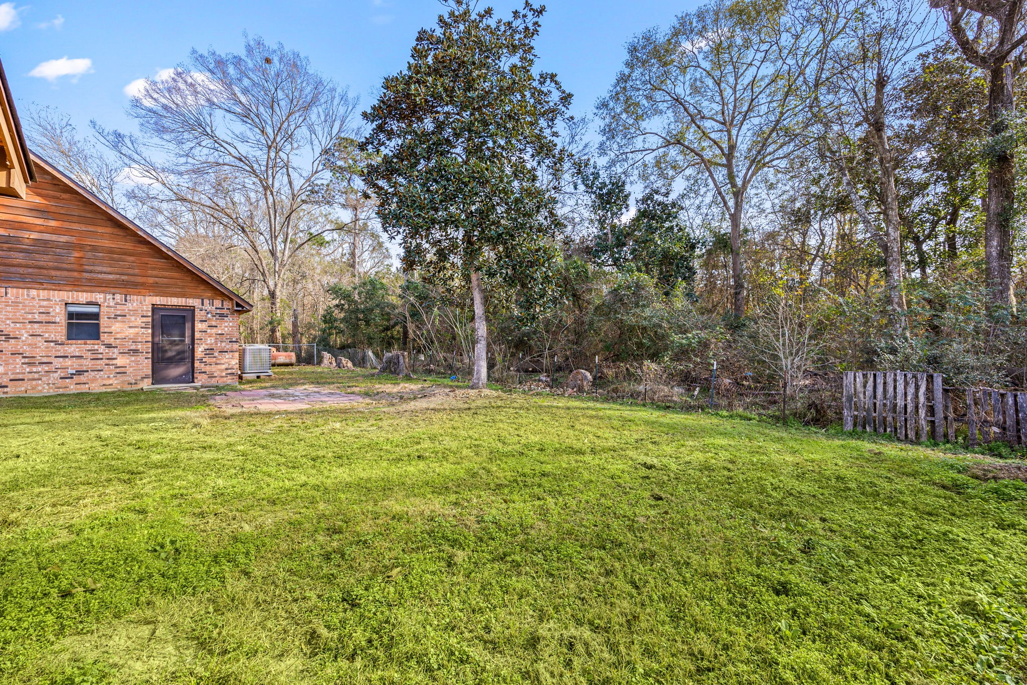 236 Pine Ridge Drive Cleveland, TX 77327 - Photo 23 of 30 a view of a house with a yard