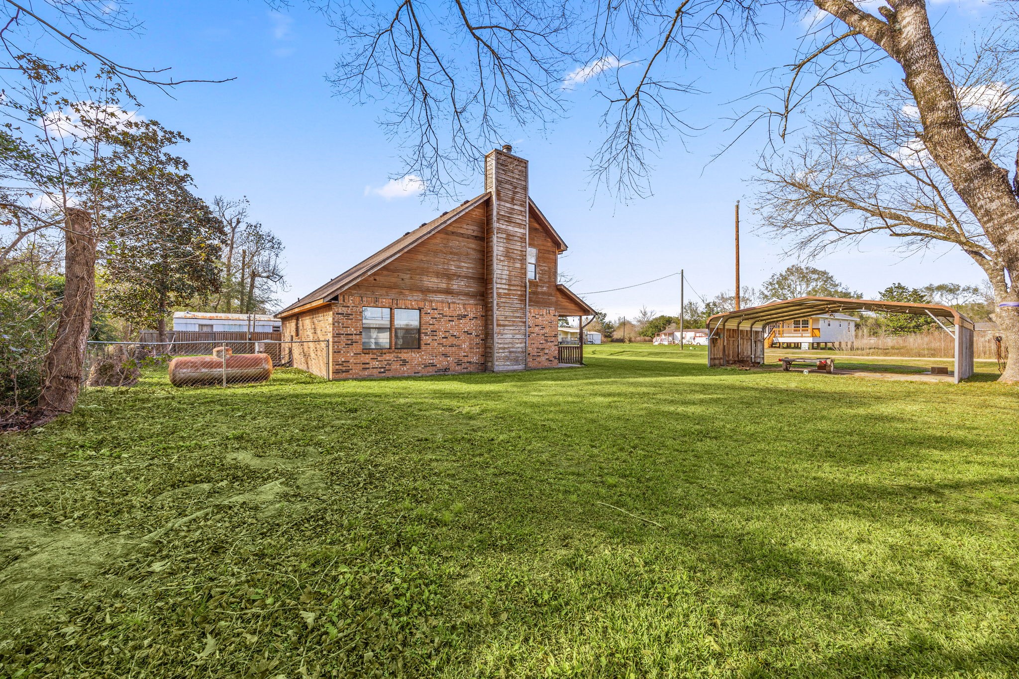 236 Pine Ridge Drive Cleveland, TX 77327 - Photo 24 of 30 a view of a house next to a big yard and large trees