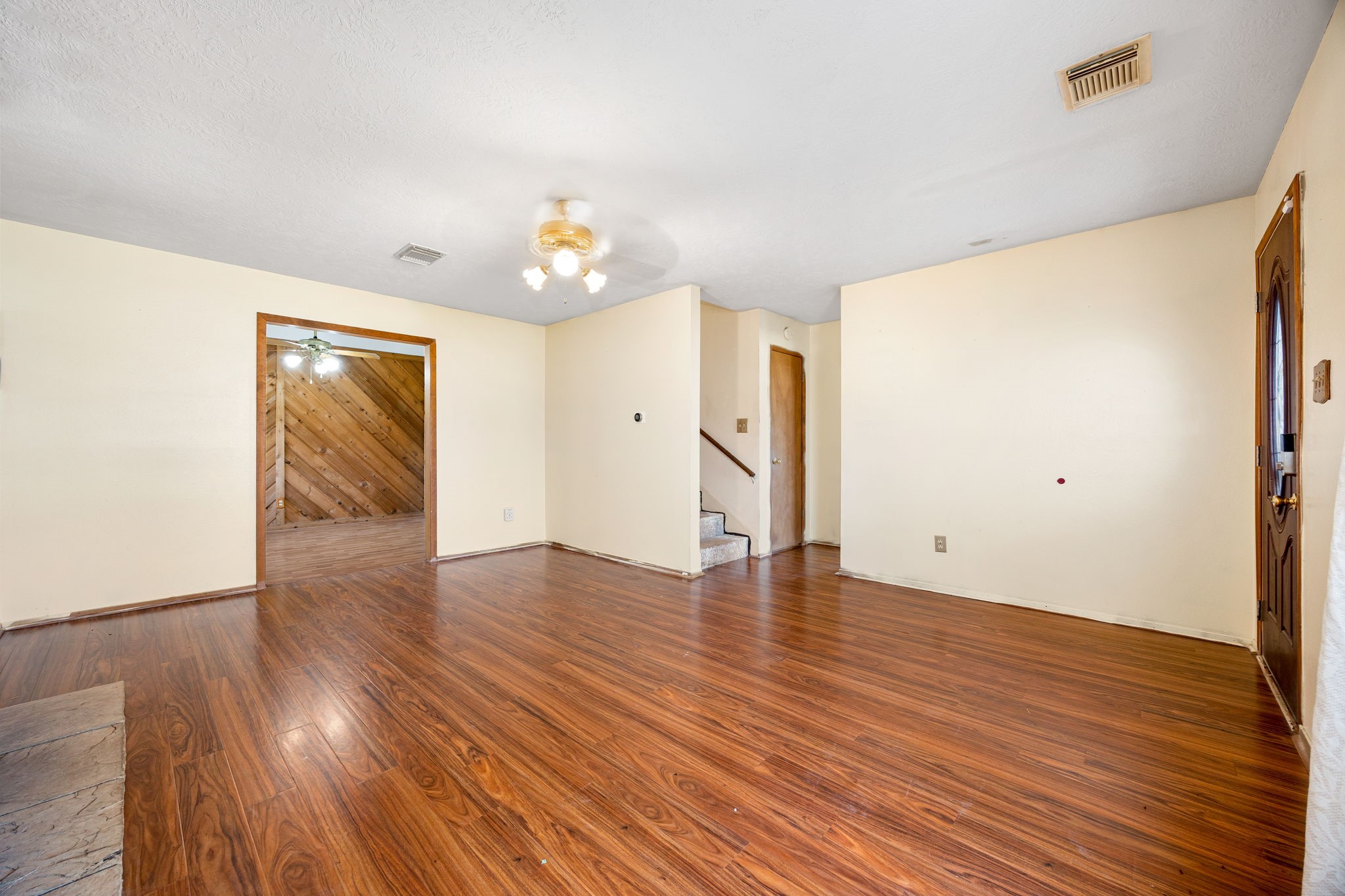 236 Pine Ridge Drive Cleveland, TX 77327 - Photo 4 of 30 an empty room with wooden floor and natural light
